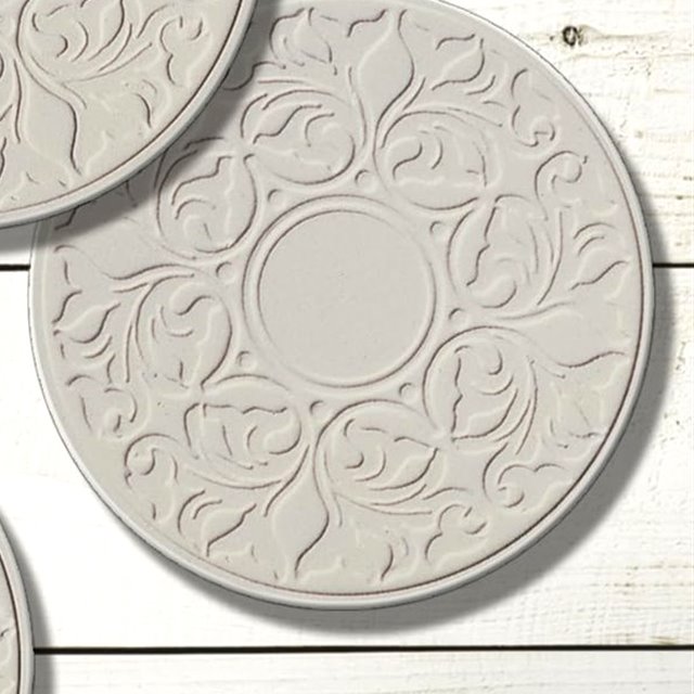 Close view of a Victorian Lace coaster, the raised pattern pressed into the stone face