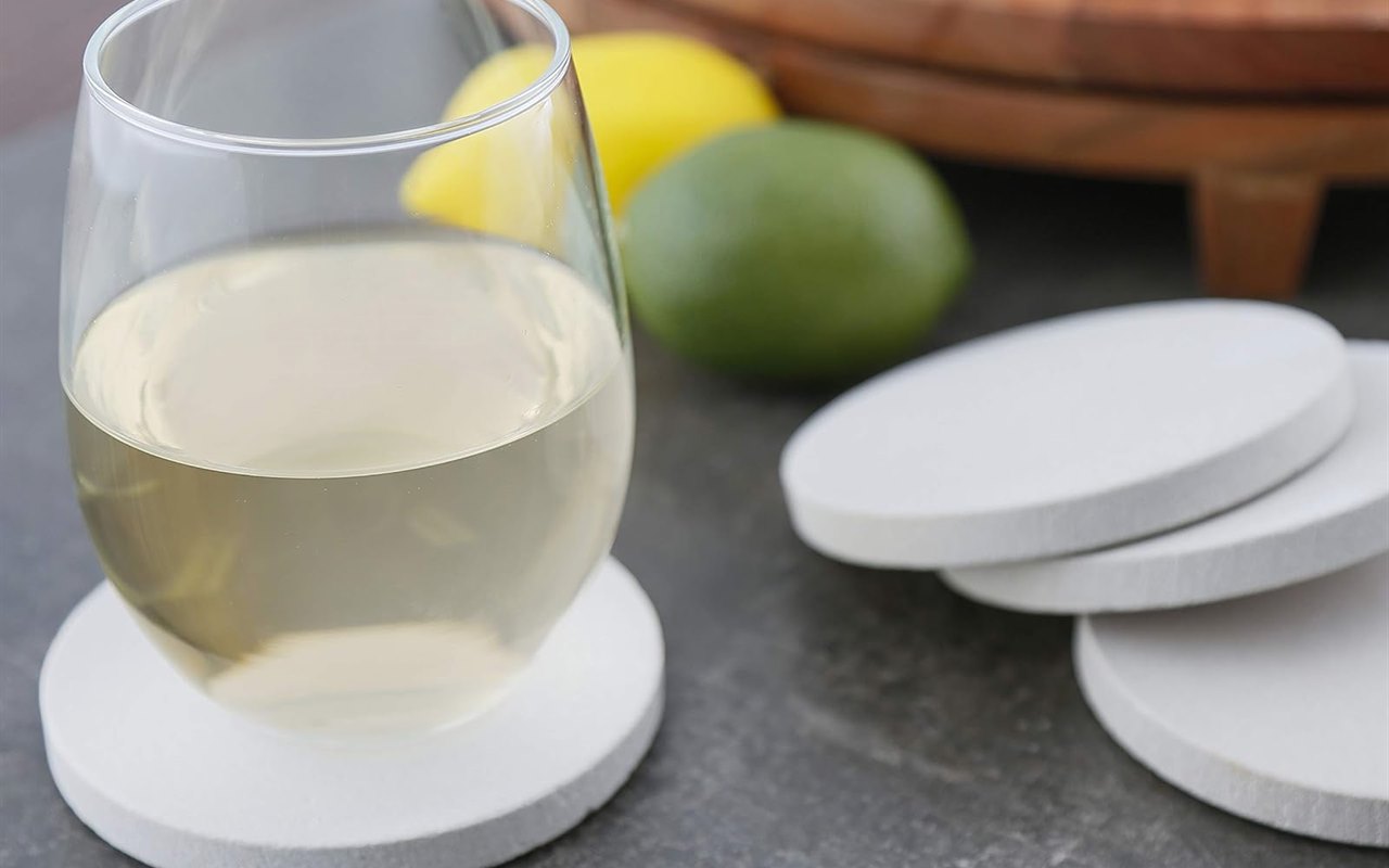 A glass of white wine on a pale Thirstystone sandstone coaster
