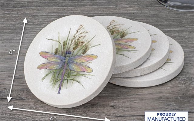 Dragonfly patterned coasters fanned out on a grey wood table